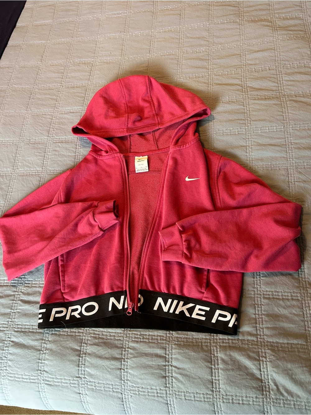 Girl’s pink Nike Pro cropped full zip